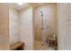 Large walk-in shower with light beige tile and wooden bench at 1571 Oceanview Dr, St Petersburg, FL 33715