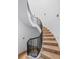 Elegant curved staircase with black iron railings and marble steps at 1571 Oceanview Dr, St Petersburg, FL 33715