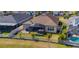 House with fenced backyard, pool, and surrounding houses at 17671 Bright Wheat Dr, Lithia, FL 33547