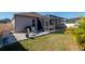 Backyard with screened patio, grass, and pavers at 17671 Bright Wheat Dr, Lithia, FL 33547