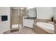 Spa-like bathroom featuring a soaking tub, walk-in shower, and double sinks at 17671 Bright Wheat Dr, Lithia, FL 33547