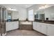 Elegant bathroom with double vanities, soaking tub, and walk-in shower at 17671 Bright Wheat Dr, Lithia, FL 33547