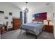 Spacious bedroom with queen bed, dresser, and large window at 17671 Bright Wheat Dr, Lithia, FL 33547