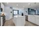Spacious kitchen with white cabinets, large island, and stainless steel appliances at 17671 Bright Wheat Dr, Lithia, FL 33547