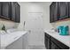Convenient laundry room with washer, dryer, and ample cabinet space at 17671 Bright Wheat Dr, Lithia, FL 33547