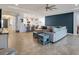 Open living room with sectional sofa and kitchen view at 17671 Bright Wheat Dr, Lithia, FL 33547