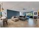 Bright living room with a large sectional sofa and access to a patio at 17671 Bright Wheat Dr, Lithia, FL 33547