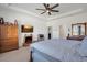 Comfortable main bedroom with king-size bed, ceiling fan, and ample storage at 17671 Bright Wheat Dr, Lithia, FL 33547