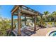 Relaxing pergola with lounge chairs near the pool at 18207 Canopy Pl, Lakewood Ranch, FL 34211