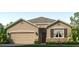 One-story home with tan siding, stone accents, and a two-car garage at 18212 Canopy Pl, Lakewood Ranch, FL 34211