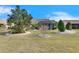 Landscaped backyard with mature trees and shrubs at 2003 Captiva Ct, Sun City Center, FL 33573