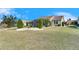 Spacious backyard with landscaping and screened enclosure at 2003 Captiva Ct, Sun City Center, FL 33573