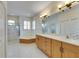 Large bathroom with double vanity, soaking tub, and separate shower at 2003 Captiva Ct, Sun City Center, FL 33573