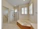 Bathroom with walk-in shower and corner bathtub at 2003 Captiva Ct, Sun City Center, FL 33573