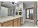 Updated bathroom with wood vanity, walk-in shower, and window at 2003 Captiva Ct, Sun City Center, FL 33573