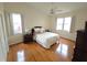 Bright bedroom with wood floors, a queen-size bed, and ample natural light at 2003 Captiva Ct, Sun City Center, FL 33573