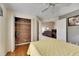 Bright bedroom with wood floors, closet, and view of living area at 2003 Captiva Ct, Sun City Center, FL 33573
