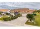 One-story home with tile roof, landscaping, and paver driveway at 2003 Captiva Ct, Sun City Center, FL 33573