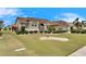 One-story house with tile roof, well-manicured lawn, and mature shrubs at 2003 Captiva Ct, Sun City Center, FL 33573