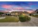 One-story house with tile roof and landscaping, at sunset at 2003 Captiva Ct, Sun City Center, FL 33573