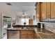 Kitchen with granite countertops, wood cabinets, and view of backyard at 2003 Captiva Ct, Sun City Center, FL 33573