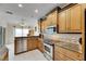 Modern kitchen featuring granite countertops and wood cabinets at 2003 Captiva Ct, Sun City Center, FL 33573
