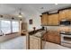 Kitchen features granite countertops, wood cabinets, and stainless steel appliances at 2003 Captiva Ct, Sun City Center, FL 33573