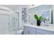 Bathroom with dual vanity, walk-in shower, and modern fixtures at 2123 Hallier Cv, Wesley Chapel, FL 33543