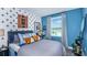 Stylish bedroom with a full-size bed and unique wall decor at 2123 Hallier Cv, Wesley Chapel, FL 33543