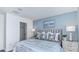 Bedroom with king-size bed, blue accent wall, and ample natural light at 2123 Hallier Cv, Wesley Chapel, FL 33543