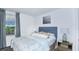 Cozy bedroom with a full-size bed and calming decor at 2123 Hallier Cv, Wesley Chapel, FL 33543