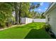 Landscaped backyard with artificial turf and mature trees at 2126 7Th N Ave, St Petersburg, FL 33713