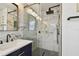 Modern bathroom with navy vanity, marble tile, and walk-in shower at 2126 7Th N Ave, St Petersburg, FL 33713