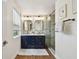 Elegant bathroom with double vanity, marble tile, and frameless shower at 2126 7Th N Ave, St Petersburg, FL 33713