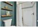 Updated bathroom with white subway tile shower, pebble floor, and floating shelves at 2126 7Th N Ave, St Petersburg, FL 33713