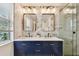 Elegant bathroom with double vanity, marble tile, and frameless shower at 2126 7Th N Ave, St Petersburg, FL 33713