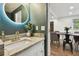 Modern powder room with granite countertop, a white sink, and a round lighted mirror at 2126 7Th N Ave, St Petersburg, FL 33713