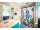 Charming bathroom with teal vanity and nautical-themed shower curtain at 2461 Moore Haven W Dr, Clearwater, FL 33763