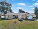 Ranch-style home with attached garage and landscaped yard at 2461 Moore Haven W Dr, Clearwater, FL 33763