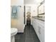 Stylish bathroom with white cabinets, granite countertop, and a walk-in shower at 2601 2Nd Ct, Palm Harbor, FL 34684