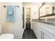 Clean bathroom, featuring a walk-in shower, new vanity, and dark slate floor at 2601 2Nd Ct, Palm Harbor, FL 34684
