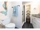 Updated bathroom with white cabinets, granite countertop, and a walk-in shower at 2601 2Nd Ct, Palm Harbor, FL 34684