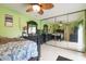 Bedroom with lime green walls, ceiling fan, and mirrored closet doors at 2601 2Nd Ct, Palm Harbor, FL 34684