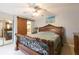 Main bedroom with a large wooden sleigh bed and barn door at 2601 2Nd Ct, Palm Harbor, FL 34684