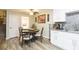 Casual dining area with round table and chairs, near kitchen and laundry at 2601 2Nd Ct, Palm Harbor, FL 34684