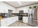Modern kitchen featuring white cabinets, granite countertops and stainless steel appliances at 2601 2Nd Ct, Palm Harbor, FL 34684
