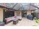 Screened patio with seating area, fire pit, and grill at 2601 2Nd Ct, Palm Harbor, FL 34684