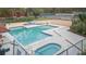 Community pool and spa with surrounding deck at 2601 2Nd Ct, Palm Harbor, FL 34684