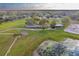 Aerial view of a farm with stables and pond at 2972 Lake Saxon Dr, Land O Lakes, FL 34639