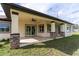 Covered patio with tile flooring, ceiling fan, and sliding glass doors at 2972 Lake Saxon Dr, Land O Lakes, FL 34639